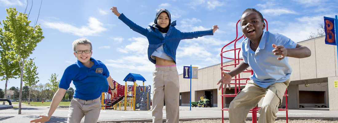 Three students playing on the playground